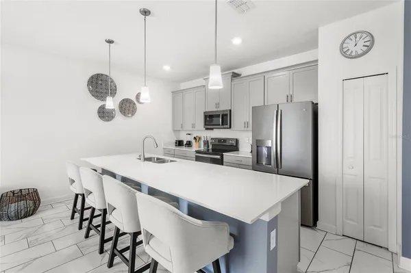a kitchen with refrigerator cabinets and wooden floor