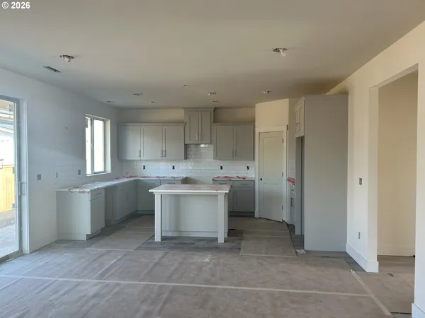 a view of an empty room with a fireplace and a window