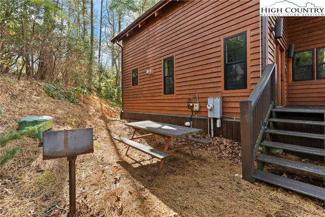 a front view of a house with stairs and a garden