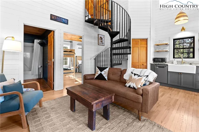 a living room with furniture a rug and a chandelier