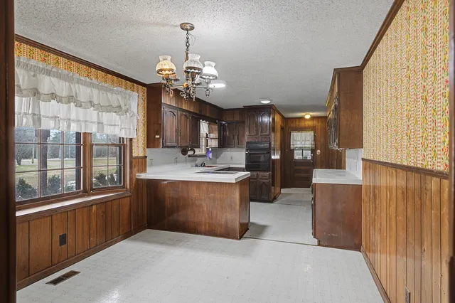 a kitchen with stainless steel appliances granite countertop a stove and a refrigerator