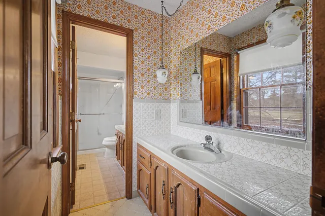 a bathroom with a sink toilet and shower