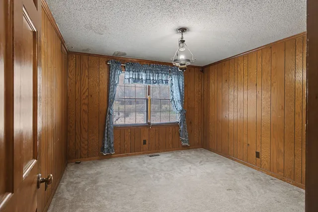 a bathroom with a granite countertop sink a toilet and a shower