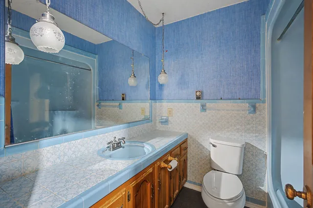 a front view of a house with a yard covered in snow