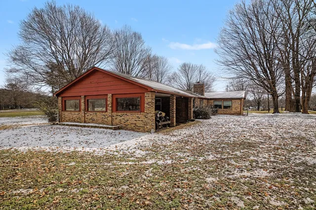 a front view of house with yard and trees