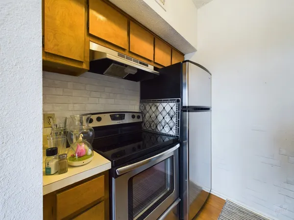 a kitchen with a sink a stove and cabinets