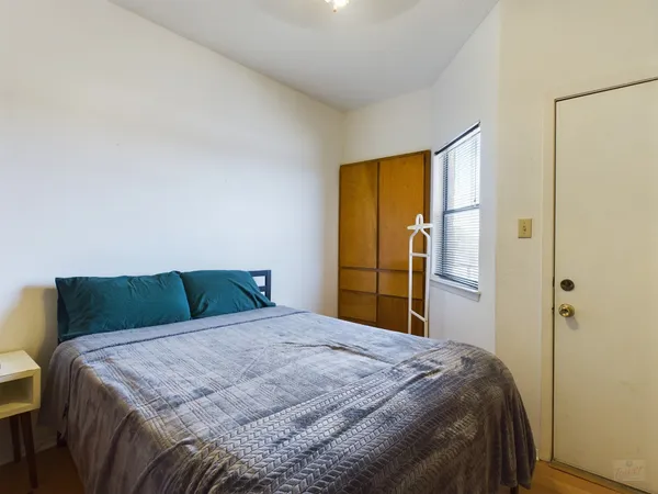 a bedroom with a bed and a window