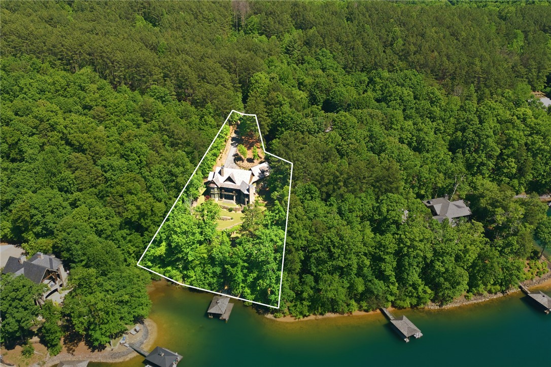 130 River Ridge Road Sunset, SC 29685 - Photo 38 of 47 Perched amidst lush greenery, this waterside residence boasts private dock access and an expansive treed lot.
