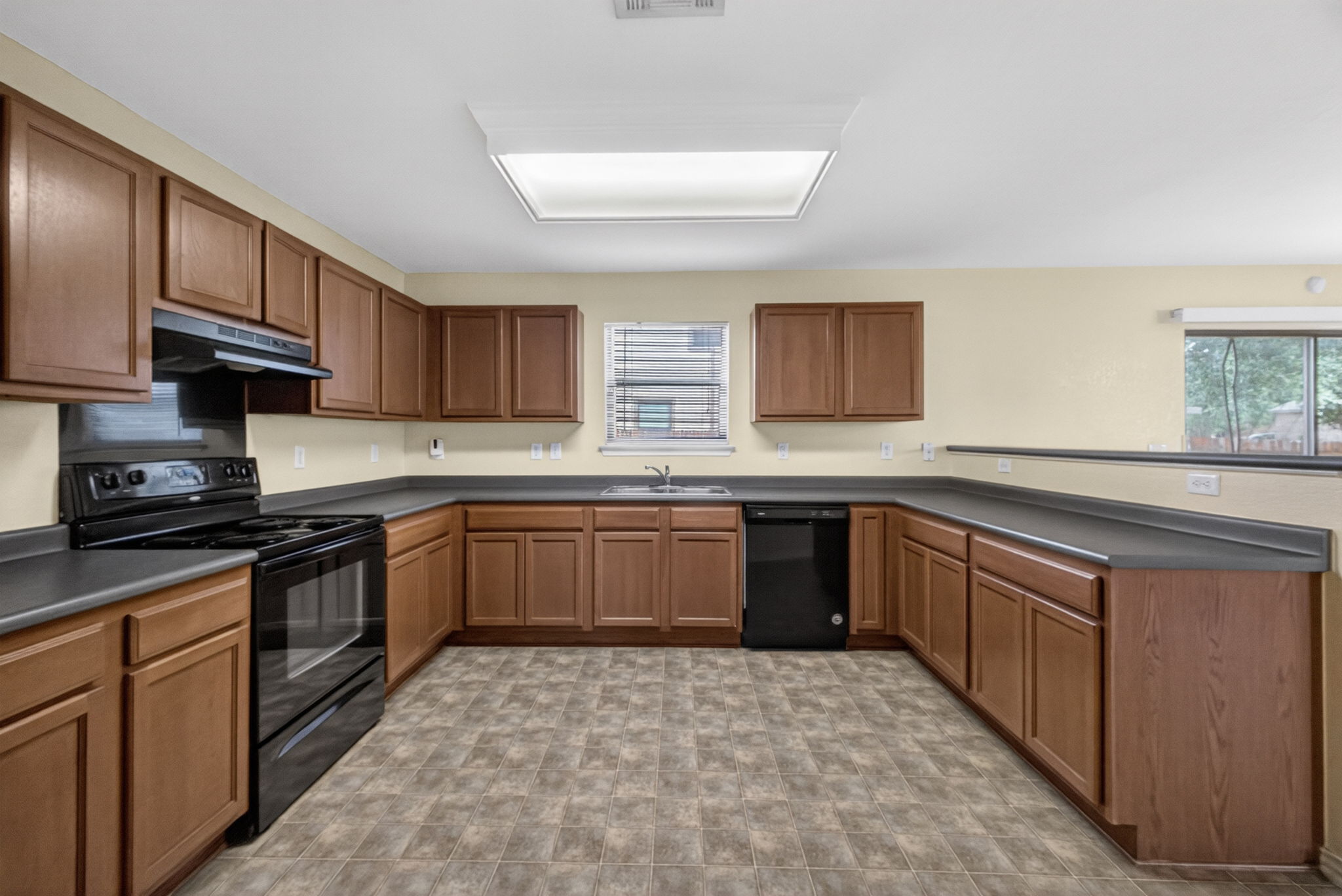 8813 Wiley Way Austin, TX 78747 - Photo 10 of 39 Functional kitchen with ample cabinet space and black appliances