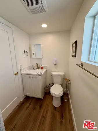 a bathroom with a sink toilet and vanity