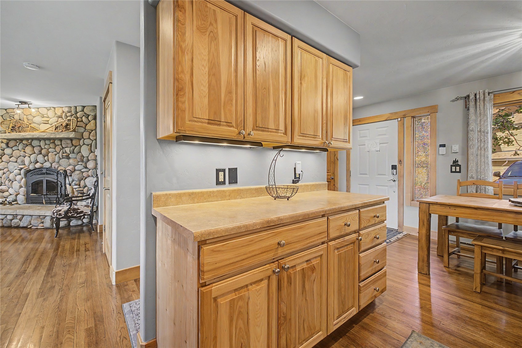 6726 Ryan Gulch Road, Unit 6726 Wildernest, CO 80498 - Photo 10 of 39 a kitchen with stainless steel appliances granite countertop a stove a sink dishwasher and a refrigerator with wooden floor