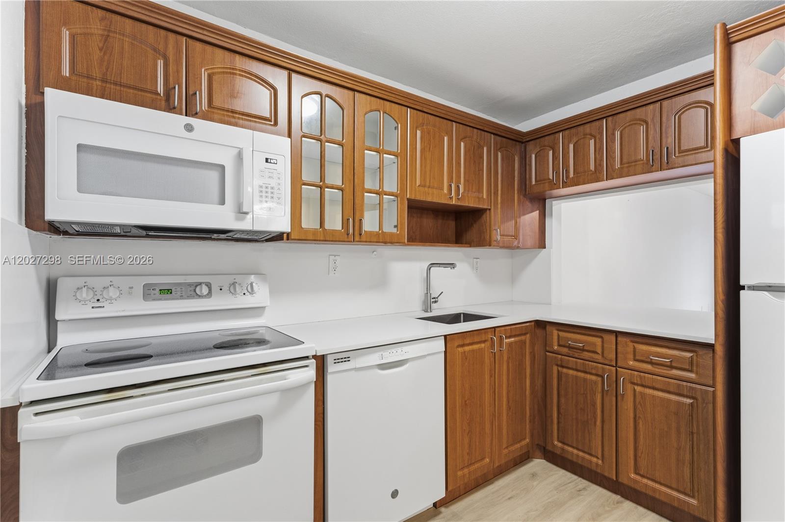 1665 Bay Road, Unit 322 Miami Beach, FL 33139 - Photo 2 of 24 a kitchen with stainless steel appliances granite countertop a sink stove and cabinets