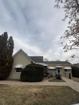 a view of a house with a yard and roof