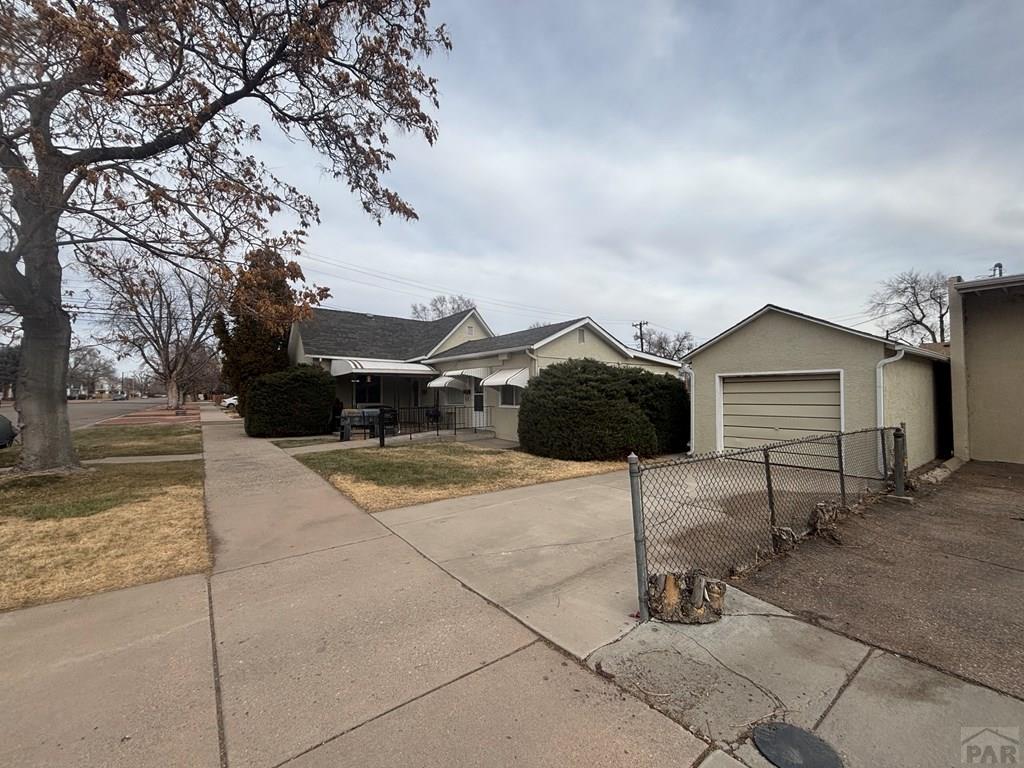 113 West Routt Avenue Pueblo, CO 81004 - Photo 6 of 20 a view of a house with backyard and a tree