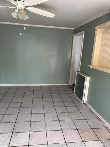 a room with a wooden floor and a large window