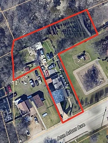 a front view of a house with a yard and potted plants