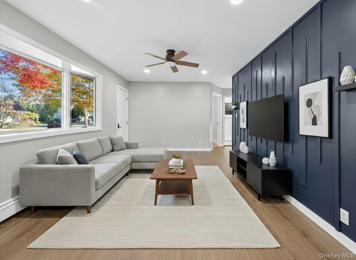 14 Muncey Road Bay Shore, NY 11706 - Photo 3 of 13 Living area featuring light wood finished floors, recessed lighting, and ceiling fan (virtually staged)