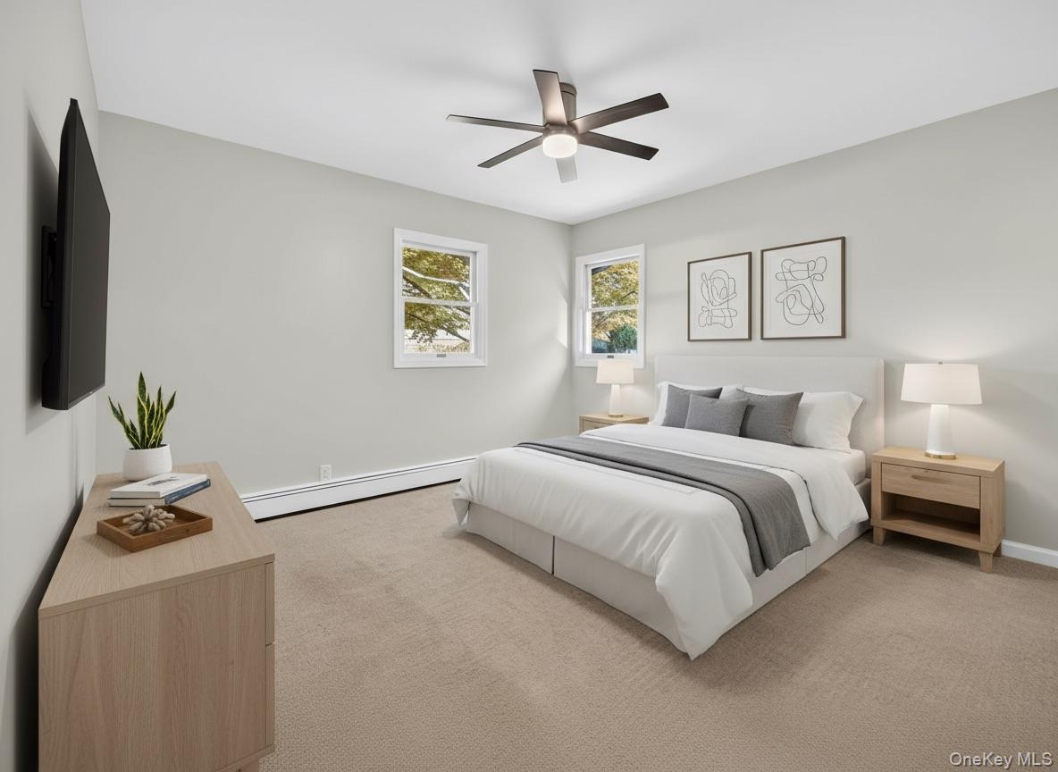 14 Muncey Road Bay Shore, NY 11706 - Photo 4 of 13 Bedroom with light carpet, a baseboard radiator, and ceiling fan (virtually staged)