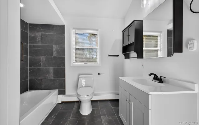 a bathroom with a sink toilet a bath tub and shower