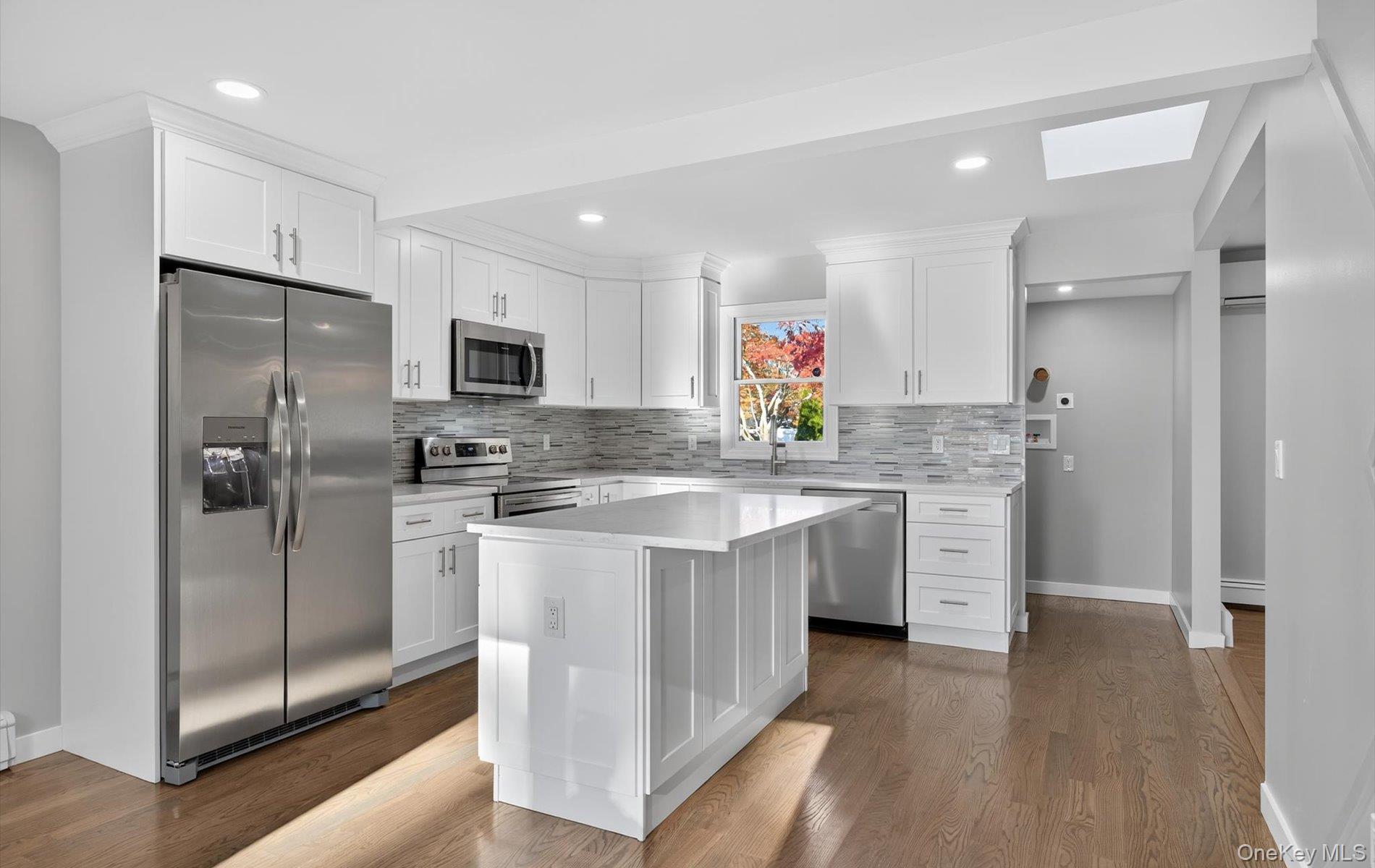 14 Muncey Road Bay Shore, NY 11706 - Photo 8 of 13 Kitchen featuring appliances with stainless steel finishes, white cabinets, tasteful backsplash, and recessed lighting