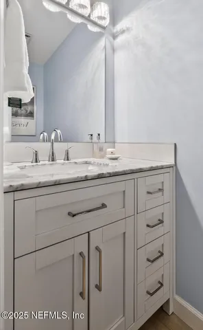 a view of a white house with table and chairs in front of it