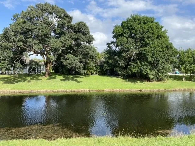 a view of a lake with houses in the background