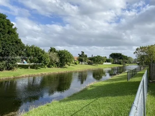 a view of backyard with wooden fence