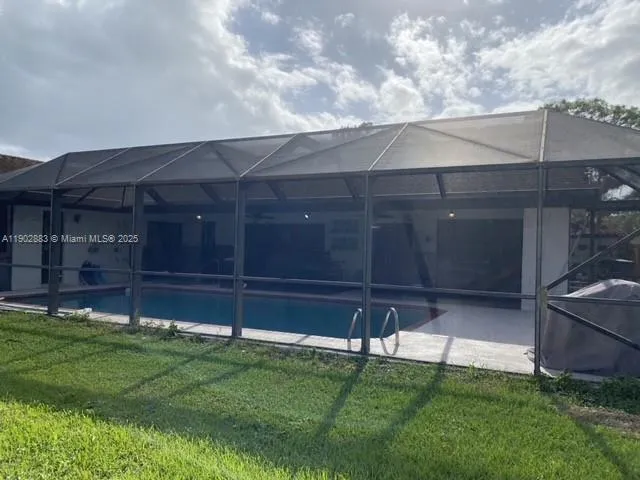 a spacious bedroom with a bed and a chandelier