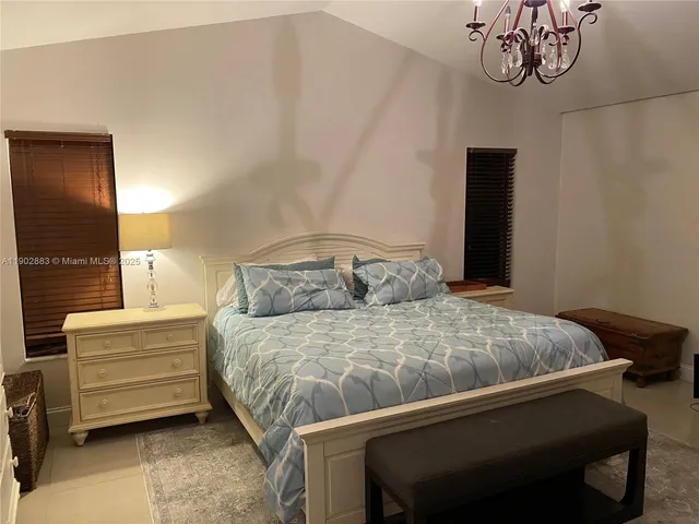 a bedroom with a bed and a night stand