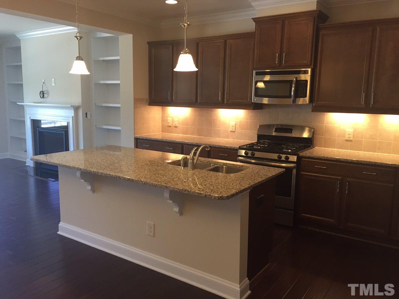 741 Fallon Grove Way Raleigh, NC 27608 - Photo 5 of 16 a kitchen with sink a microwave a stove and refrigerator