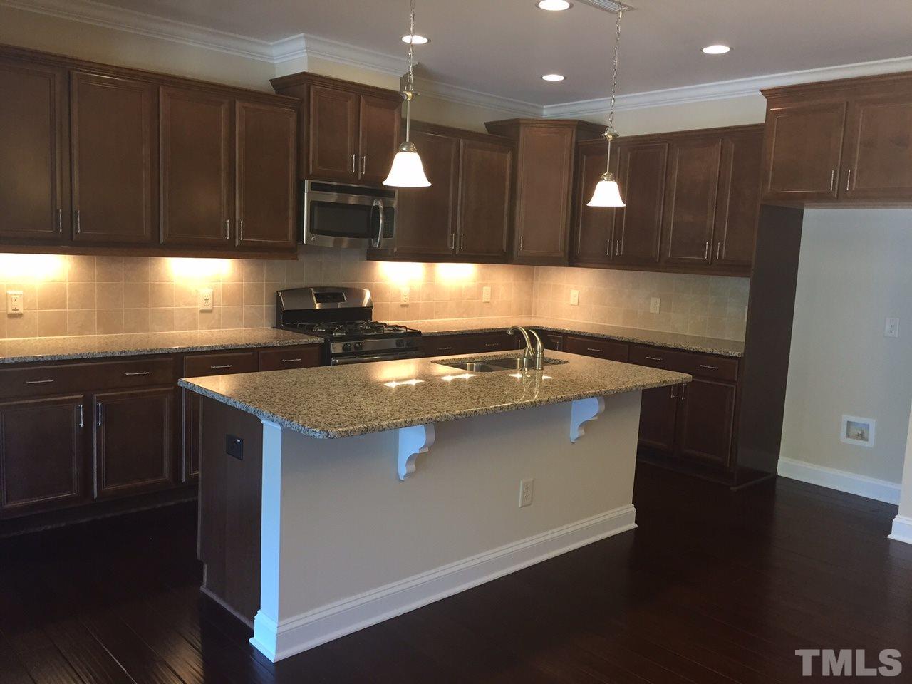 741 Fallon Grove Way Raleigh, NC 27608 - Photo 6 of 16 a kitchen with stainless steel appliances granite countertop a sink a stove and a refrigerator