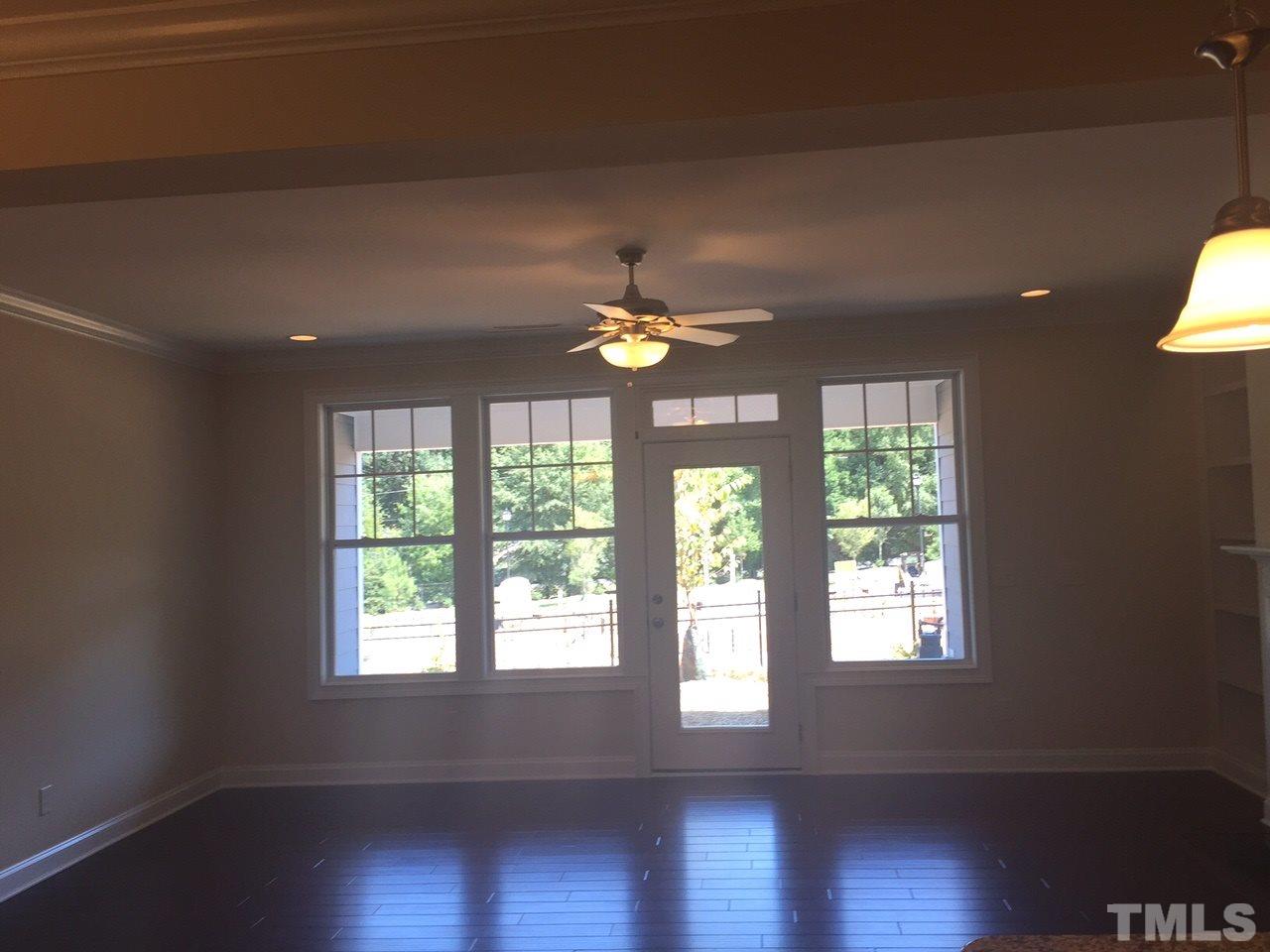741 Fallon Grove Way Raleigh, NC 27608 - Photo 9 of 16 a view of an empty room with wooden floor and a window
