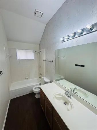 a bathroom with a double vanity sink toilet and shower