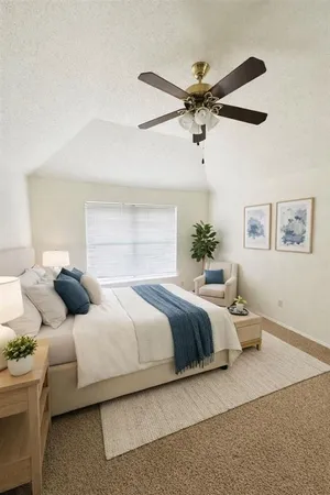 a bedroom with a bed and ceiling fan