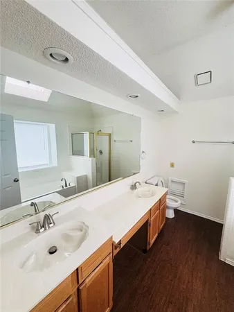 a bathroom with a tub sink and mirror