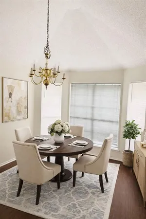 a view of a dining room with furniture and a potted plant