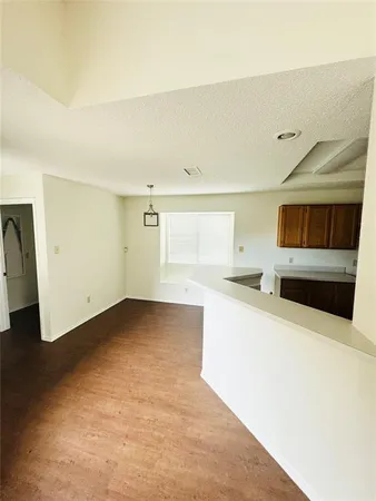 a view of a room with a dishwasher and a refrigerator