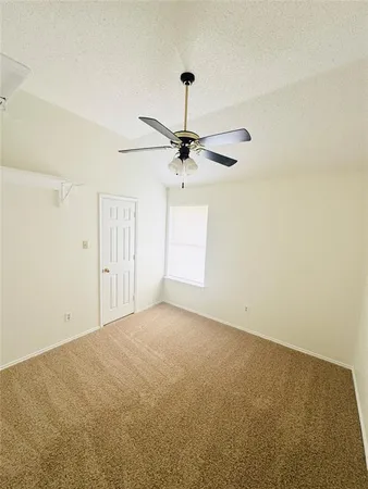 a view of a livingroom with a ceiling fan and window