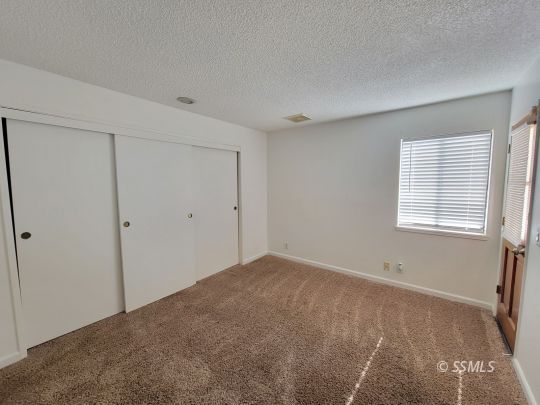 218 Kennedy Court Ridgecrest, CA 93555 - Photo 3 of 19 a view of an empty room with a window