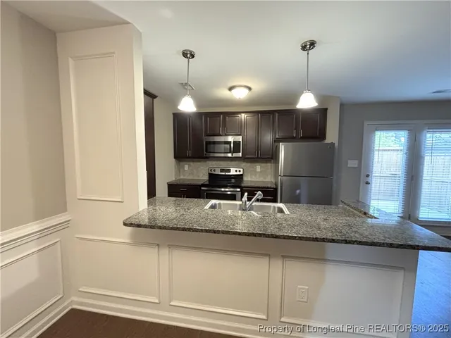 a kitchen with appliances and cabinets