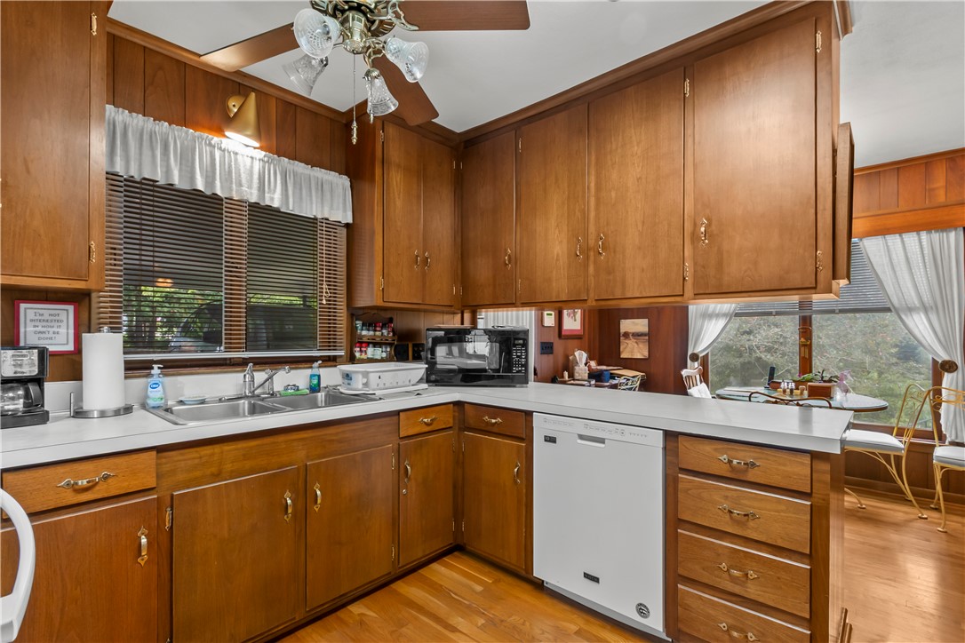 118 Blair Road Belton, SC 29627 - Photo 30 of 49 Rich wood paneling and matching cabinetry define this classic kitchen layout.