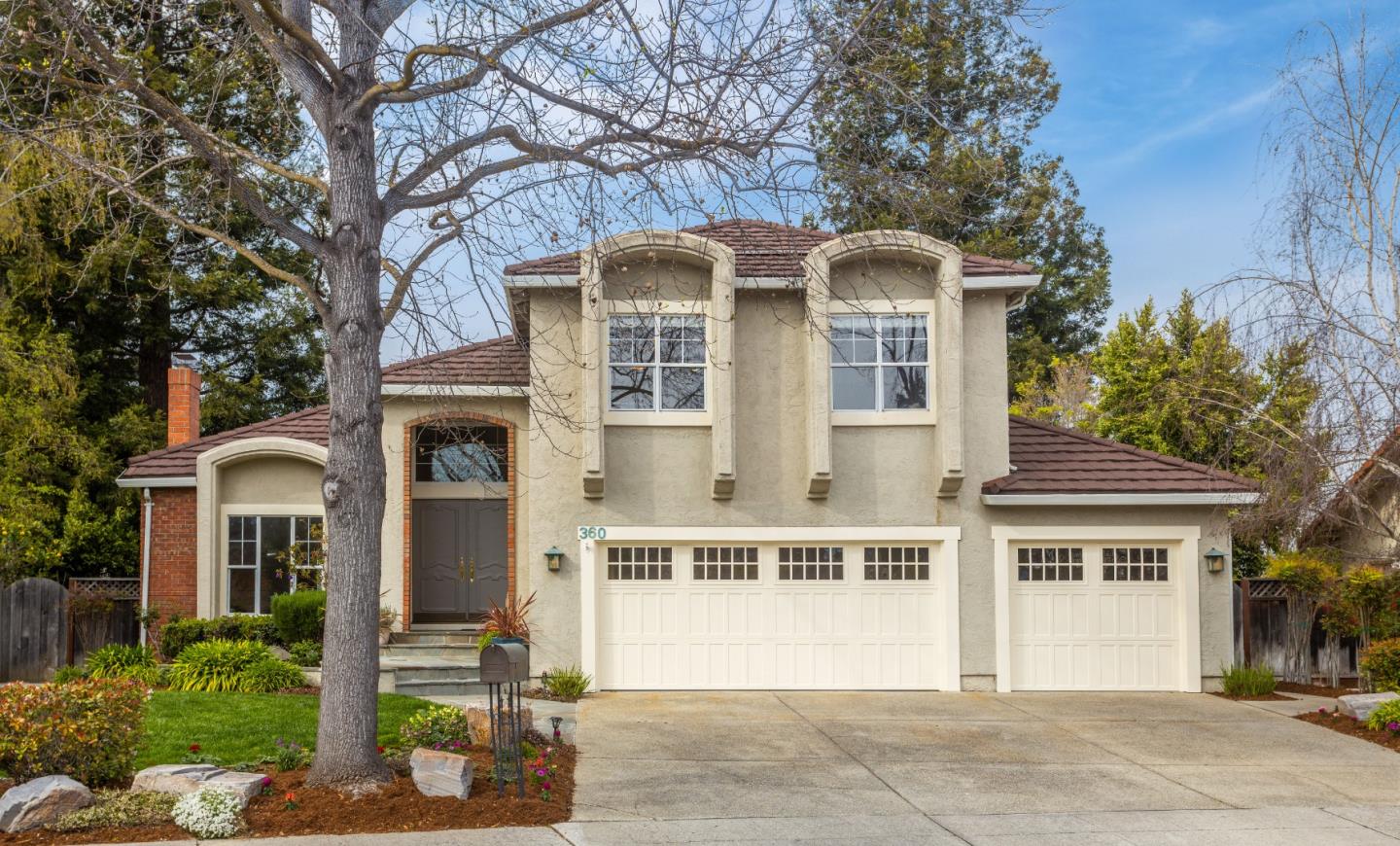 a front view of a house with a garden