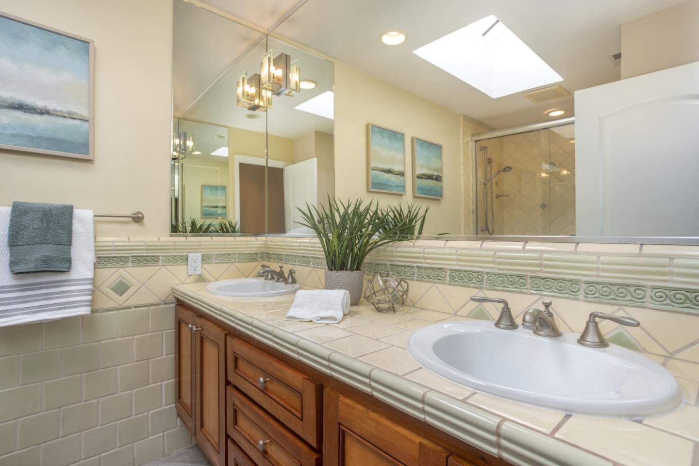 360 Apricot Lane Mountain View, CA 94040 - Photo 14 of 25 a bathroom with a granite countertop sink a large mirror and a shower