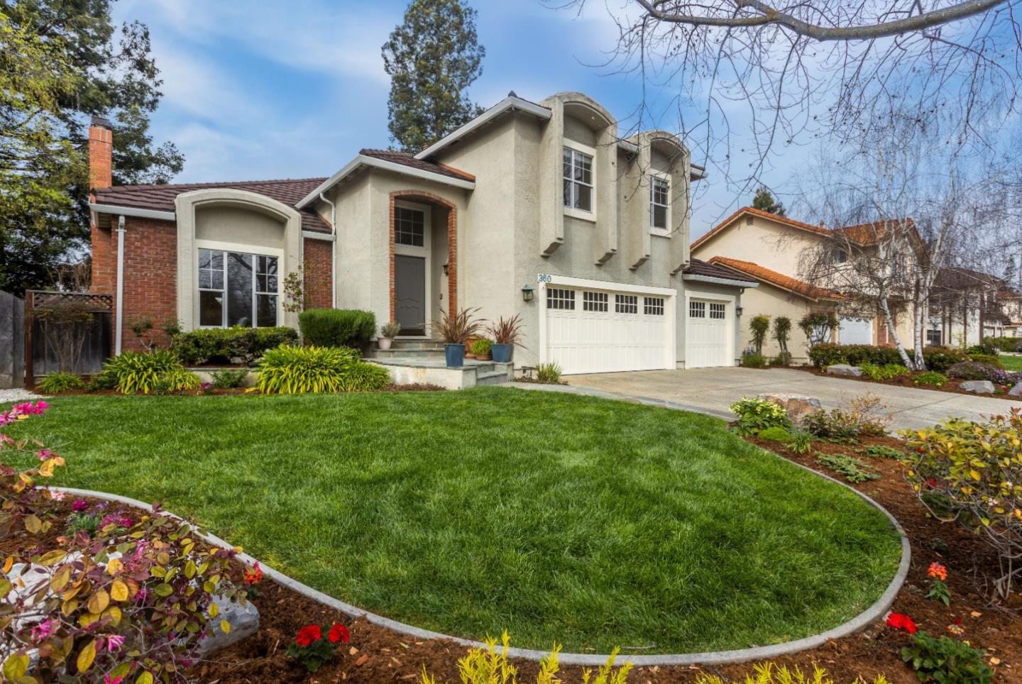 360 Apricot Lane Mountain View, CA 94040 - Photo 2 of 25 a view of a white house with a big yard potted plants and large tree