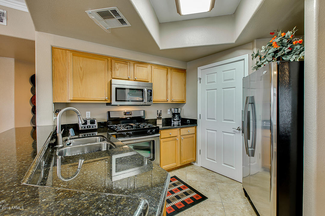 10030 West Indian School Road, Unit 269 Phoenix, AZ 85037 - Photo 12 of 34 a kitchen with a sink appliances and cabinets