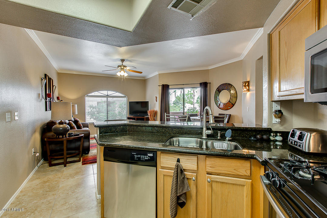 10030 West Indian School Road, Unit 269 Phoenix, AZ 85037 - Photo 14 of 34 a kitchen with stainless steel appliances granite countertop a stove and a sink