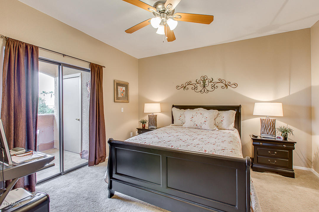 10030 West Indian School Road, Unit 269 Phoenix, AZ 85037 - Photo 17 of 34 a bedroom with a bed and a chandelier