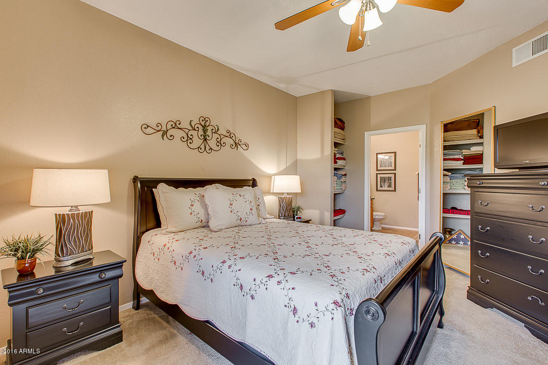 10030 West Indian School Road, Unit 269 Phoenix, AZ 85037 - Photo 18 of 34 a bedroom with a bed and a dresser in it