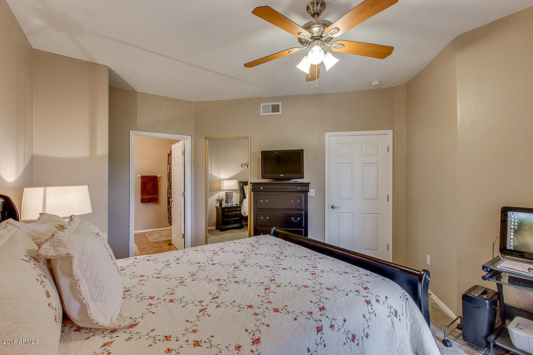 10030 West Indian School Road, Unit 269 Phoenix, AZ 85037 - Photo 20 of 34 a bedroom with a bed and a flat screen tv