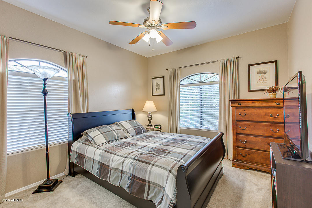 10030 West Indian School Road, Unit 269 Phoenix, AZ 85037 - Photo 22 of 34 a bedroom with a bed and a dresser